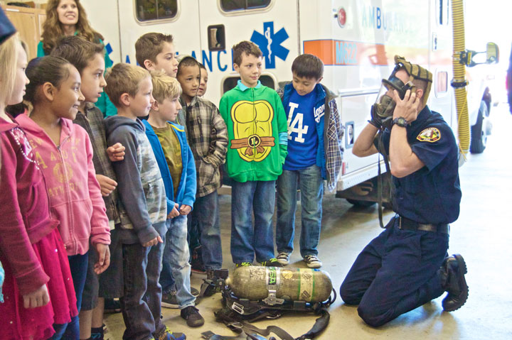 First graders learn about firefighting: On Tuesday, May 19, the Idyllwild School first-grade class visited Idyllwild Fire Station. Here, an Idyllwild firefighter demonstrates the use of mask and oxygen tanks in case of a fire.Photo by Gallagher Goodland