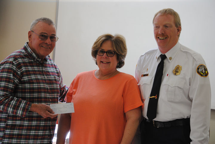 Sue Weisbart, incoming Rotary Anns president, presented a $500 check to Idyllwild Fire Protection District. Accepting the check for firefighter protective gear were Commission President Jerry Buchanan (left) and Fire Chief Patrick Reitz (right).Photo by J.P. Crumrine 