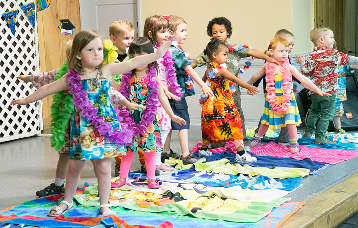 The Li’l Critters “surf” to open their graduation at Town Hall Saturday morning. Photo by Jenny Kirchner