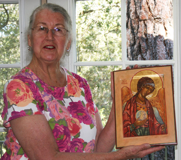 Pine Cove artist Nancy Borchers holding one of her own icon designs. Borchers has studied Russian iconography and confines her work to that school. Photo by Marshall Smith 