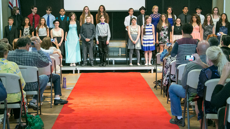 Idyllwild School’s eighth grade promoting class of 2015 stands proudly while friends and family take photos from the audience. Photos by Jenny Kirchner