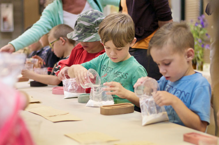 Aiden Pritchett joins in the fun with other kindergarten and first graders making molds of animal prints at the Nature Center on Wednesday. Photo by Gallagher Goodland