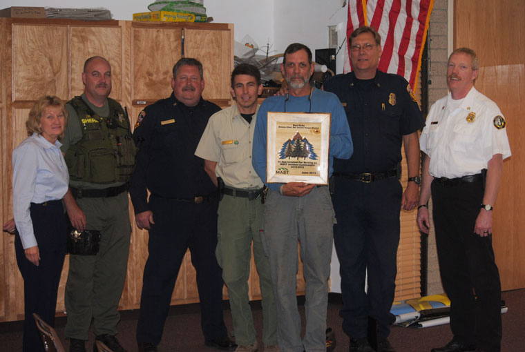 Mountain Area Safety Taskforce officials honored retired Forest Service San Jacinto District Fire Manager Dan Felix (center, holding plaque) at last week’s meeting. From left are Edwina Scott, executive director of the Mountain Communities Fire Safe Council; Frank James, Riverside County Sheriff’s deputy; Gregg Bratcher, Riverside County Fire Department Mountain Unit forester; Freddie Espinoza, current San Jacinto District fire manager; Bill Weiser, RCFD Mountain Division chief; and Patrick Reitz, Idyllwild Fire chief. Photo by J.P. Crumrine