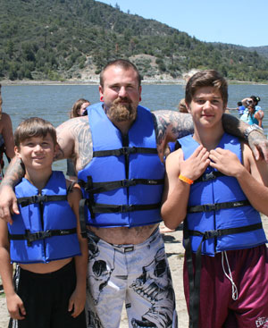 First-time Hill visitors Joseph Leslie (center) and sons Anthony Duran (left) and Alex Duran, of Yucaipa, wait for the signal to enter the newly opened water park. Photo by Marshall Smith