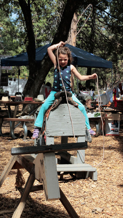 Candice Cook, left, fired up to try her hand at roping.  Photo by John Drake 