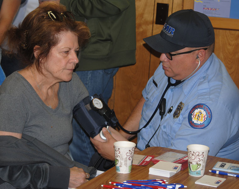 American Medical Response held an open house at the Pine Cove Water District boardroom Saturday. Here, AMR Paramedic Richard Alvarado takes Sherry Edwards’ blood pressure. Photo by J.P. Crumrine