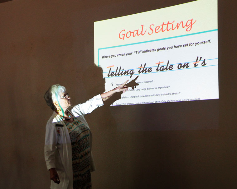 Margaret Rondeau describes handwriting analysis at the Caine Learning Center Friday evening.Photo by John Drake 