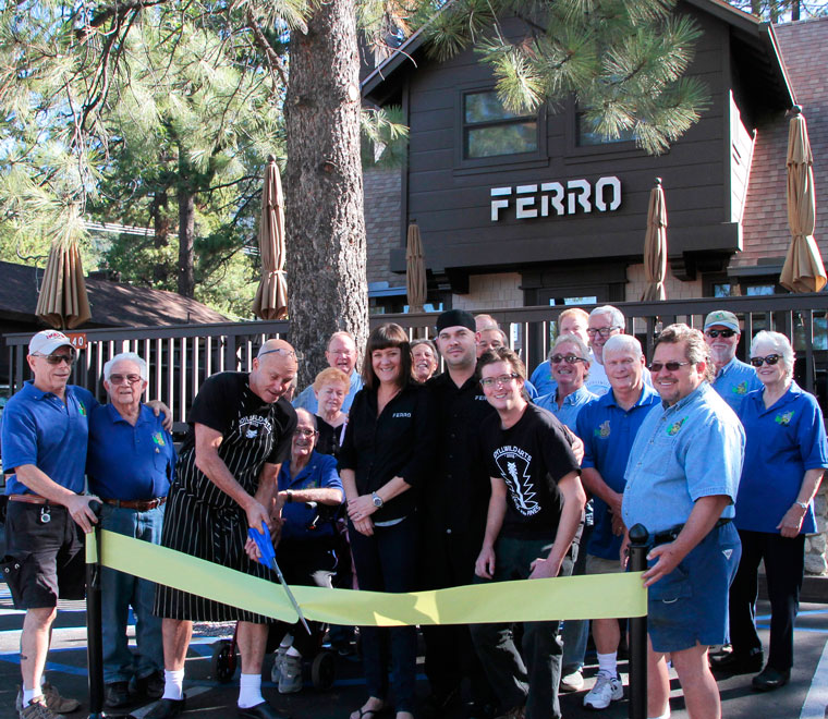 Surrounded by Rotarians from Idyllwild’s Rotary Club, Frank Ferro holds the scissors for the ribbon cutting. Accompanying him from Ferro are (from left) wife and co-owner Lori Ferro, Chef Geoff Brown and Justin Holmes. They cut the ribbon to hail the opening of Ferro Restaurant on Monday morning. Rotarians are, from left, Chuck Weisbart, Earl Parker, Charlie Wix (seated), Cathy Duncan, Chuck Streeter, Jeffrey Cohen, Steve Espinosa, Craig Coopersmith, Danny Richardson and John Graham.Back row, from left behind Coopermith, Chris Scott, Scott Fisher Thom Wallace and Reba Coulter. Photo by John Drake