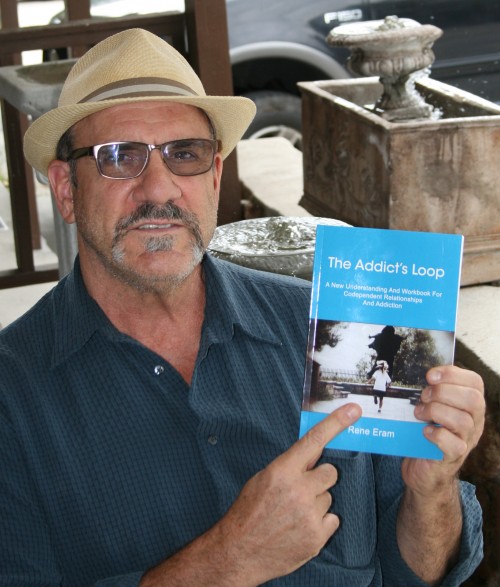 Rene Eram, commercial TV director, gallery owner and author with a copy of his new book, “The Addict’s Loop: A New Understanding and Workbook for Codependent Relationships and Addiction.”Photo by Marshall Smith