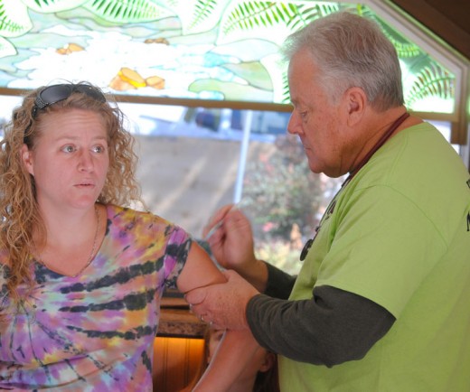 Ouch! Shannon Johnston receives her flu vaccine from Dr. Ken Browning during the Idyllwild Heath Fair, which was held at Browning’s office, Fern Creek Medical Center, and sponsored by the Idyllwild HELP Center. Photo by JP Crumrine 