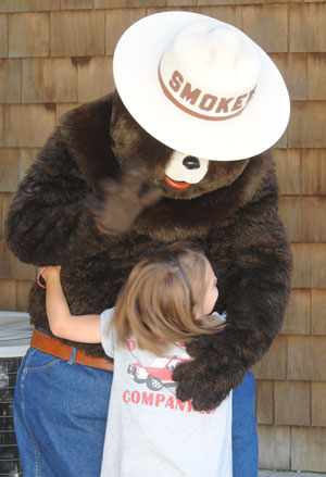 Smokey Bear hugs Bailey Alavarez during the Idyllwild Fire Station open house for Fire Prevention Week, Saturday, Oct. 10. Photo by JP Crumrine