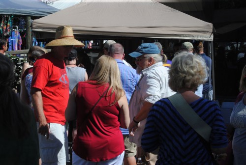 Many wine tasting patrons wait for a sip of Middle Ridge’s offering on Saturday’s Art Walk and Wine Tasting. Photo by JP Crumrine 