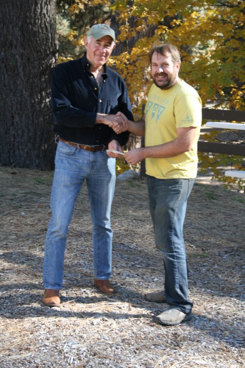 Dr. Dick Goldberg, Mountain Disaster Preparedness medical director (left) shakes hands with Kelly Schlenz, Idyllwild Pines Camp director of operations, upon reaching an agreement for Idyllwild Pines to provide campus space at McNeil Hall, the largest camp facility, for use by MDP as a medical center following a disaster. Goldberg also gave Schlenz a check for a fundraiser Schlenz was conducting in appreciation for the camp’s outreach to MDP and the community. Photo by Marshall Smith 