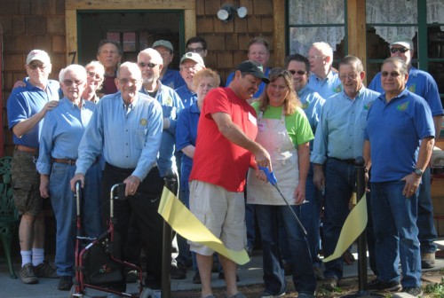 Billy and Suzanne Bailey, owners of Idyll Creations, the new craft shop in the Oakwood Village shopping center, cut the Idyllwild Rotary ribbon Monday morning. Joining them are (first row, from left) Charlie Wix, Kathy Duncan, Ric Foster and Steve Espinosa; (second row, from left), Earl Parker, Terry Kurr, Jeffrey Cohen and John Graham; and (back row are, from left) Chuck Weisbart, Craig Coopersmith, Dennis Dunbare, Roland Gaebert, Eric Gaebert, Christopher Scott, Chuck Streeter and Thom Wallace.Photo by JP Crumrine 