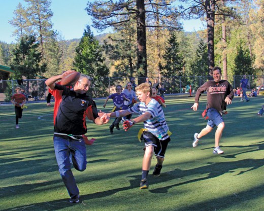 Student Zen Rose runs down teacher Brennan Priefer during the Idyllwild Middle School’s annual Turkey Bowl played Thursday, Nov. 19. The teachers prevailed again this year 14-7. Photo by John Drake 