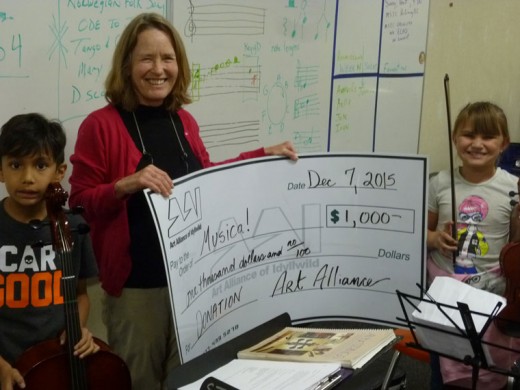 Musica! received $1,000. Anna Acheta (left), local resident and founder of Musica!, with students Ethan Martinez and Liberty Gomer. The program provides string instruments and free lessons to more than 85 students. 