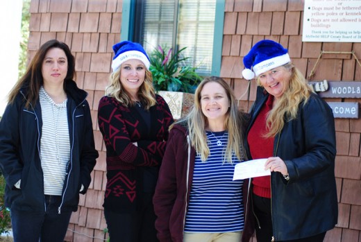 Jeri Sue Haney (right), manager of the BBVA Idyllwild branch, presents a check to Colleen Meyer, executive director of the Idyllwild HELP Center, Monday morning. Skye Zambrana (left) and Jessica Darling of BBVA (center left) participated in the gift.Photo by JP Crumrine