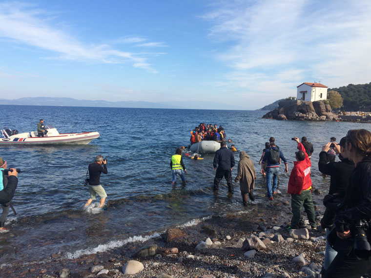 Mary A. Lehman waits with volunteers as a boat of arriving refugees, having just completed the 5-mile crossing from the Turkish coast, is pulled in by other volunteers. Photo courtesy Mary Lehman