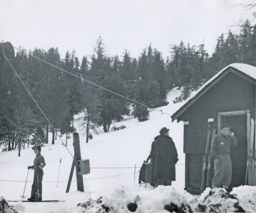 Jim Henley, in the doorway, operates the ski lift at Halona Hill in Idyllwild in the 1960s. File photo 