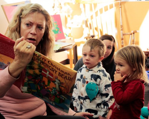 Kinsey Kretsinger and Archer Scott enjoy Idyllwild Library volunteer Virgina Lumb’s seasonally themed story time reading Monday at the library. Photo by John Drake