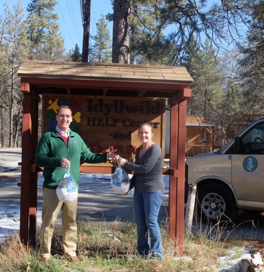 John Newman, Business Operations Executive Officer of Idyllwild Arts Academy, hands a turkey to Idyllwild HELP Center director Colleen Booth Meyer. Idyllwild Arts gave a total of 38 turkeys to the HELP Center for local families. Photo courtesy Idyllwild Arts Academy