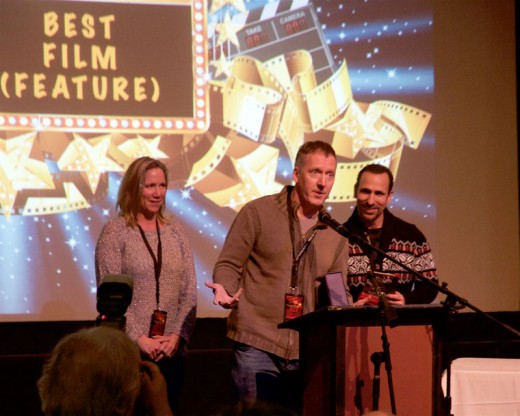 Greg Morgan (center) accepts Best Feature award for “The Boatman.” Morgan wrote and directed the film. He is flanked on the right by Oscar Torre who won Best Actor in a feature for his role in “The Boatman.” Photo by John drake