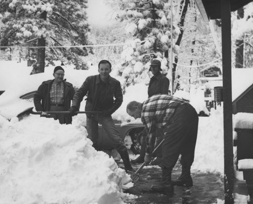 Law officers and firefighters swung shovels at the Idyllwild Fire Station in the heavy snow winter of January 1960. From left, are Brady Baker and Jim Henry of the sheriff’s department, and Dwight Metcalfe and Larry Shinn (in back) of the fire department. File photo 