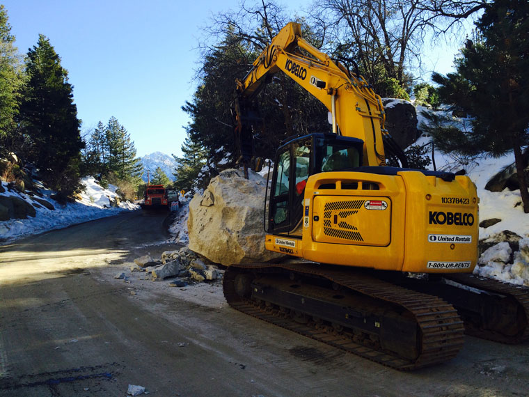 Tuesday morning, Jan. 12, Caltrans crews were using a 50,000-pound excavator equipped with a hydraulic breaker to break this boulder on Highway 243 into smaller pieces, which could be removed to allow the re-opening of the highway. Photo courtesy Terri Kasinga, Caltrans