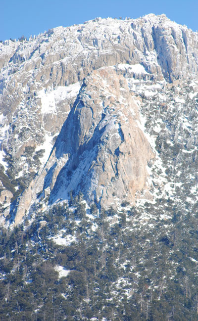 Nearly a week after the snowstorm, Tahquitz Rock remains prominently dressed in white above Idyllwild.Photo by JP Crumrine 