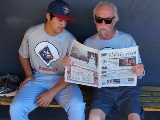 News and entertainment in Rincon, Puerto Rico, revolves around the tourist season with the presence of great weather in the winter. Luckily, Ron Pearce (right), Pine Cove part-timer, packed away a copy of the Town Crier for entertainment. Here, he is sharing the paper with one of the Puerto Rico Instructional Baseball League players, Riley Quiroz of Arizona. 