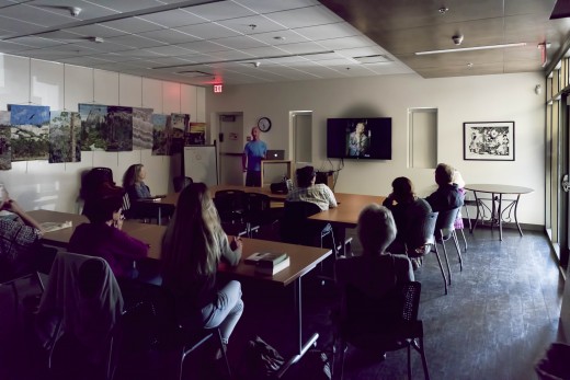 Professional photographer Jonie Millhouse shared his approach to photographing people (including Marshall Hawkins, whose photo is in the background), products and the ocean with members of Idyllwild Photographers at their March 23 session at the Idyllwild Library. Photo by Tom Kluzak 