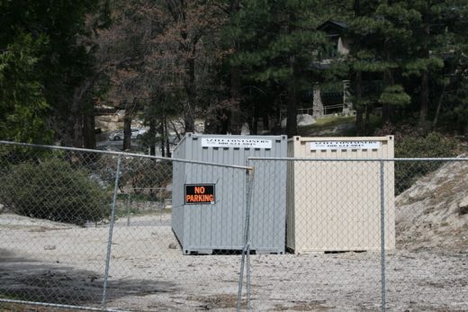 Two large metal storage containers in Fern Valley Corners have opened a Code Enforcement case and investigation. The containers, part of the business operations of Idyllwild Property Management, are allegedly in violation of county code. Photo by Marshall Smith