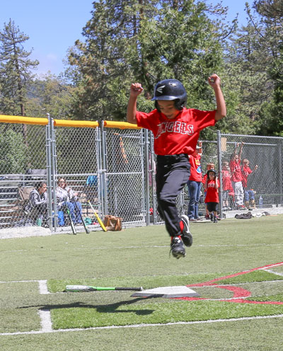 During the Town Hall Minors baseball game Saturday, this runner was very happy to score a run. Photo by Cheryl Basye 