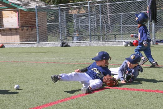 Two Padres chase down the ground ball while the Tigers’ batter heads to first during Saturday’s T-ball game. Photo by Cheryl Basye