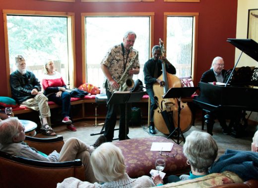 Paul Carman, on sax, Marshall Hawkins, on bass, and Barnaby Finch, on piano, entertained members of Idyllwild Arts Foundation Saturday. The concert was originally scheduled for the Lilac Gardens on South Circle, but cold weather caused a postponement until Saturday, and it moved indoors.Photo by John Drake 