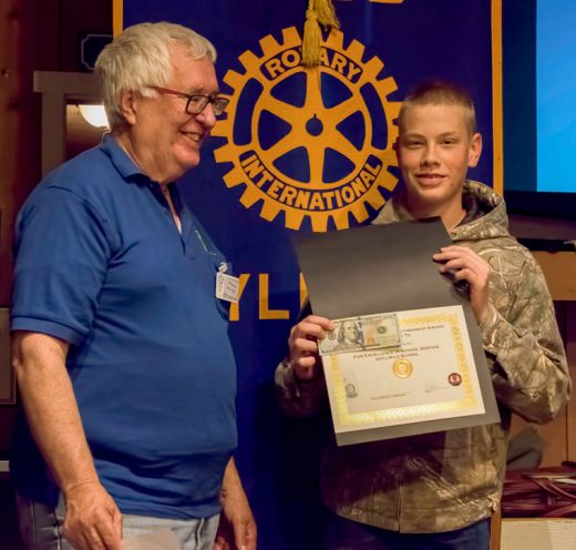 Idyllwild School student Nick Davis (right) receives the Rotary eighth-grade Citizenship Award and Scholarship from Rotarian Scott Fisher at the Idyllwild Rotary Club’s May 4 meeting. Nick was accompanied by brother Levi, mother Myla and father Chris. His teacher, Donna Mercer, praised Nick as responsible and helpful in class, and mentioned that he is looking forward to college. Photo by Tom Kluzak