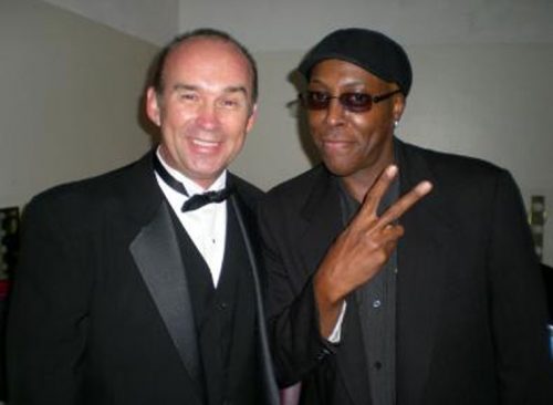 Jimmy Burns (below, left), the “teacher/comedian,” opens for Fritz Coleman. He is seen here with Arsenio Hall. Photo courtesy of Jimmy Burns 