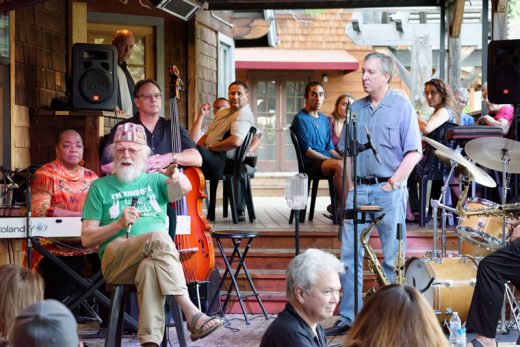 A packed house at Café Aroma on Wednesday, June 8, helped owner Hubert Halkin (seated) celebrate his 80th birthday. Aroma manager Phil Weber (standing, right) oversaw the festivities and Yve Evans (at the keyboard) and band provided entertainment. The date also marked the official opening of the Uptown Bar at the restaurant.Photo by Tom Kluzak