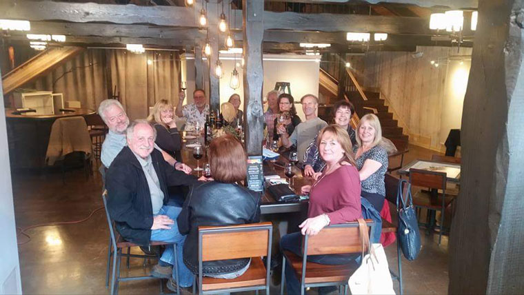 Friends celebrate with Middle Ridge Winery and Tasting Gallery owners Melody and Chris Johnston on Tuesday, May 24, the day the Johnstons received their license to sell wine to go.Photo by Dennis Gerdes 