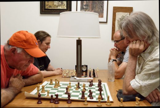 Members of the Idyllwild Chess Club concert on their games at their weekly Friday afternoon meeting at the Idyllwild Library. Attending on July 22 are, from left, Dick Goldberg, Simone Sobel, Krister Raith and DF Tweedie. Players of any skill level, even experts, can expect a friendly but challenging experience, since Sobel is ranked among the best women players in the world. Photo by Tom Kluzak