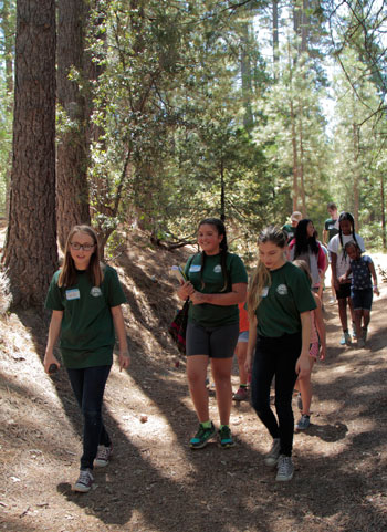 Junior Naturalists (from left) Cecile Laundré, Jessica Ruelas and Rory Wilke were among five who took visitors to the Nature Center on a walk to see historical features of the mountain last Saturday.Photo by John Drake 