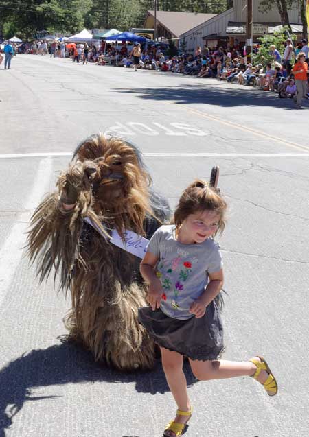 The Idyll Beast dances with one of the parade’s spectators.Photo by Tom Kluzak 