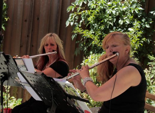 Christine Ziegenfuss-Holanda and fellow flutist Kathy Harmon-Luber playing together as Winds of Change for Tommy’s Kitchen on Saturday.Photo by John Drake 