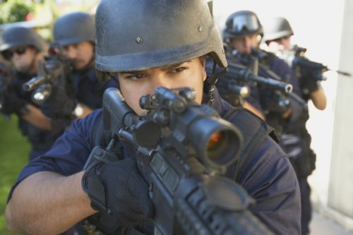 Swat officers aiming guns