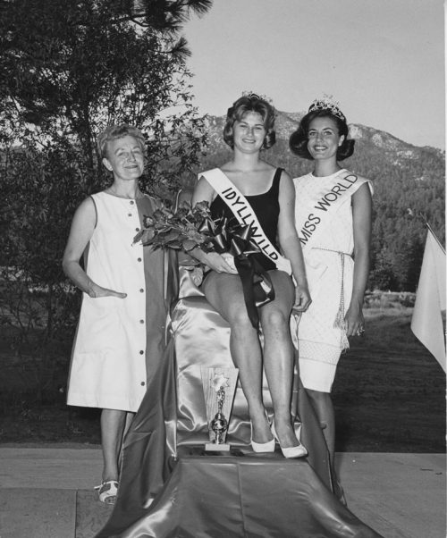 Miss Idyllwild Judy Sproul receives her crown from Miss World of 1962 Catharina Lodders of Holland (who in 1964 married Chubby Checker) at a beauty pageant held in July 1963 at Tahquitz Golf Club (now Mountain Resource Center). The woman on the left is unidentified.
