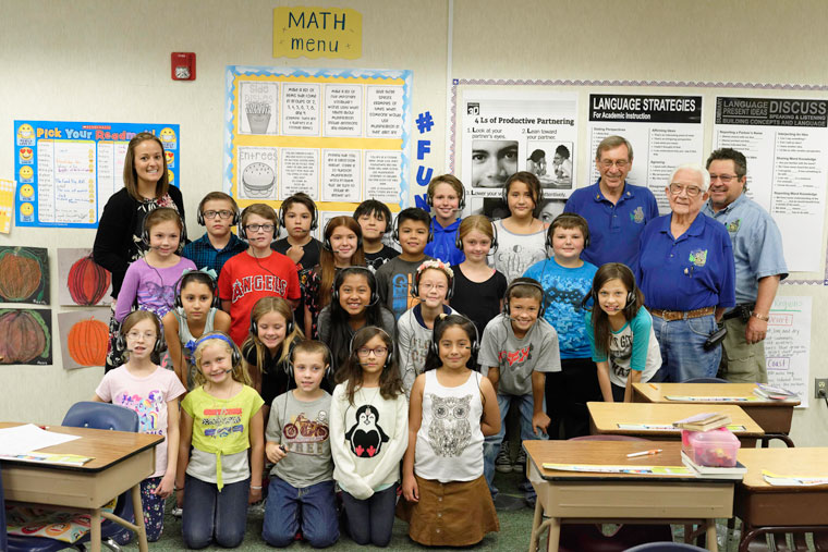 Ms. Lindsay Crater’s fourth-grade class at Idyllwild School show off their computer headsets, which the Idyllwild Rotary Club donated. The club previously gave headsets to the entire student body but met the need for additional ones this year. Pictured with the class are Crater (left) and Rotary representatives Roland Gaebert, Earl Parker and John Graham. Graham, a retired teacher, was instrumental in arranging the headsets’ donation. The headsets will allow each student to get full use out of a computer without disturbing others.  Photo by Tom Kluzak