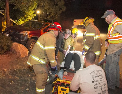 Cindi Hinds is put onto a gurney after being hit by a car Saturday evening. Idyllwild Fire transported her to the U.S. Forest Service’s Keenwild Station helipad from where she was airlifted to Desert Regional Medical Center with major injuries. According to the California Highway Patrol, at about 5 p.m., Ed Hansen was driving his Honda CRV east on North Circle Drive and struck Hinds. Both Hinds and Hansen are Idyllwild residents. Hansen was treated at the scene. Photo by Jenny Kirchner