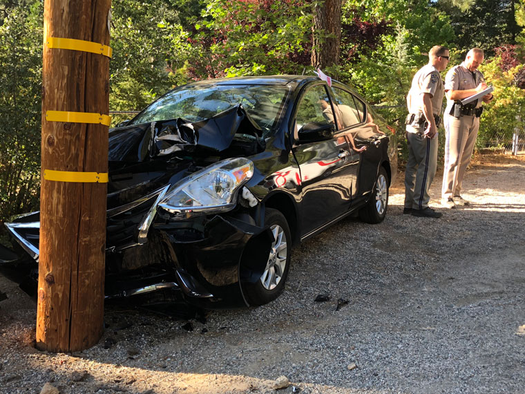 Power pole survives; Nissan succumbs