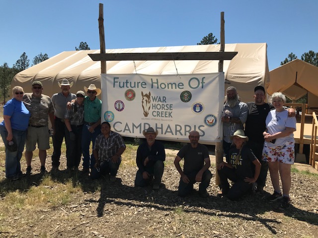 A stop at War Horse Creek for veterans in a covered wagon