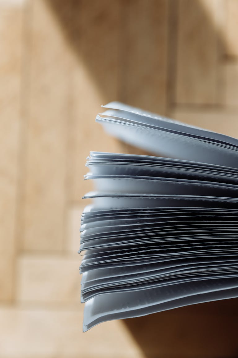 A detailed view of open book pages highlighted by sunlight, creating a serene and reflective mood.